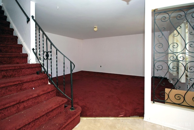 stairs featuring tile patterned floors