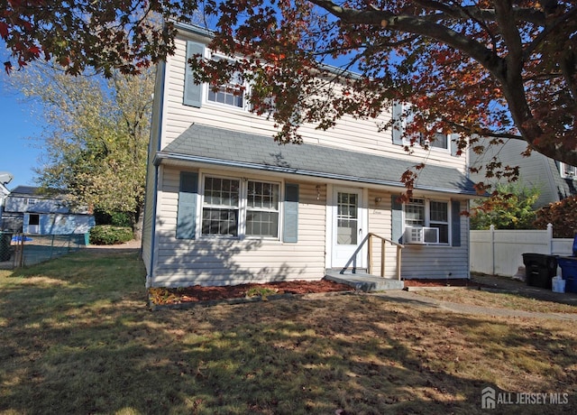 view of front facade featuring cooling unit and a front yard