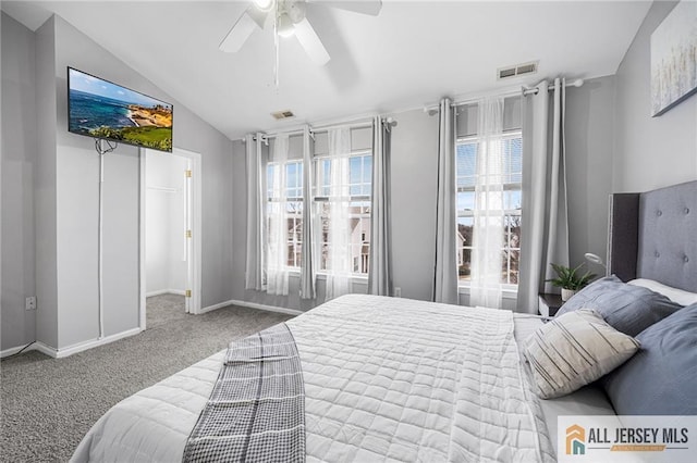 bedroom featuring vaulted ceiling, carpet flooring, visible vents, and a ceiling fan