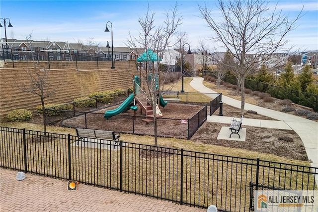 community play area with a residential view and fence