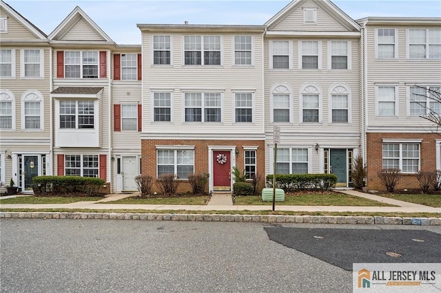 townhome / multi-family property featuring brick siding