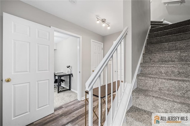 stairs with baseboards and wood finished floors