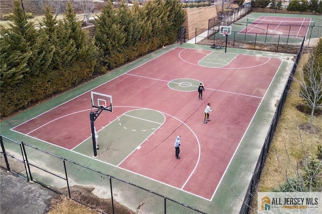 view of sport court featuring community basketball court and fence