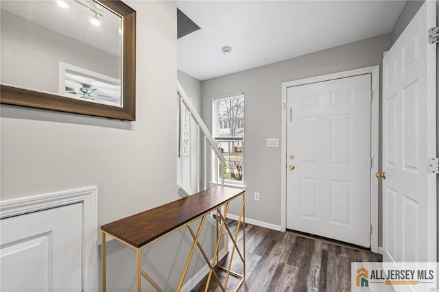 foyer entrance featuring ceiling fan, baseboards, and dark wood finished floors