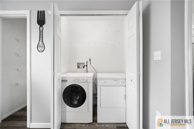 laundry room featuring dark wood-type flooring, laundry area, and washing machine and clothes dryer