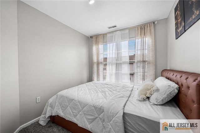 bedroom featuring carpet flooring, visible vents, and baseboards