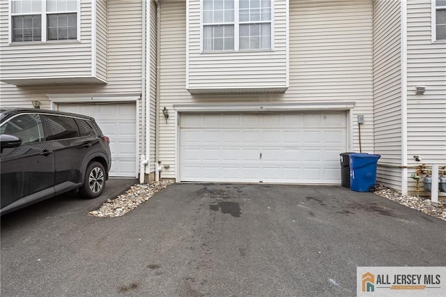 garage featuring aphalt driveway