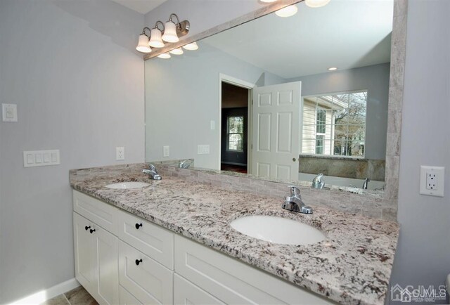 bathroom with tile patterned flooring and double vanity