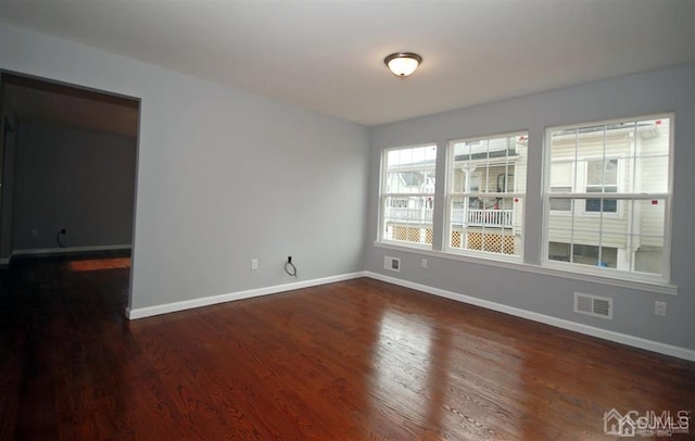 unfurnished room featuring dark hardwood / wood-style flooring