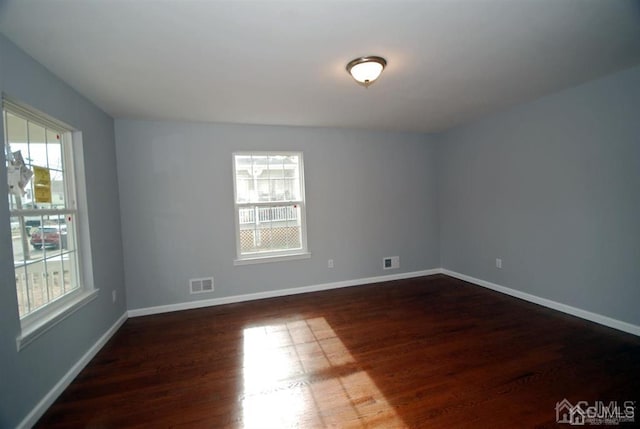 spare room featuring wood-type flooring