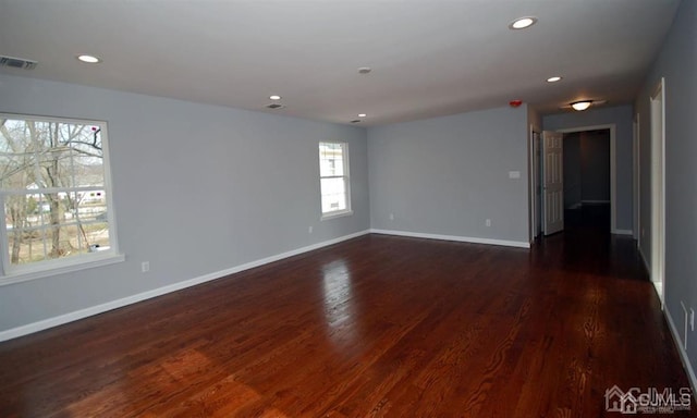 empty room with dark hardwood / wood-style floors