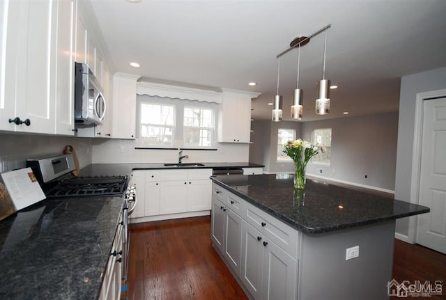 kitchen featuring white cabinetry, dark hardwood / wood-style floors, appliances with stainless steel finishes, and a kitchen island