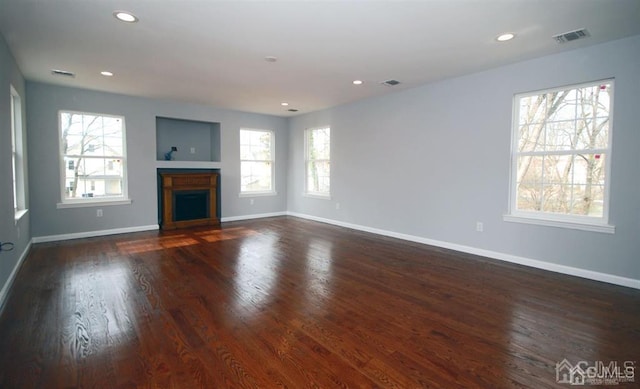 unfurnished living room featuring dark wood-type flooring