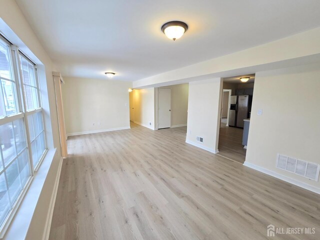 empty room with light hardwood / wood-style flooring