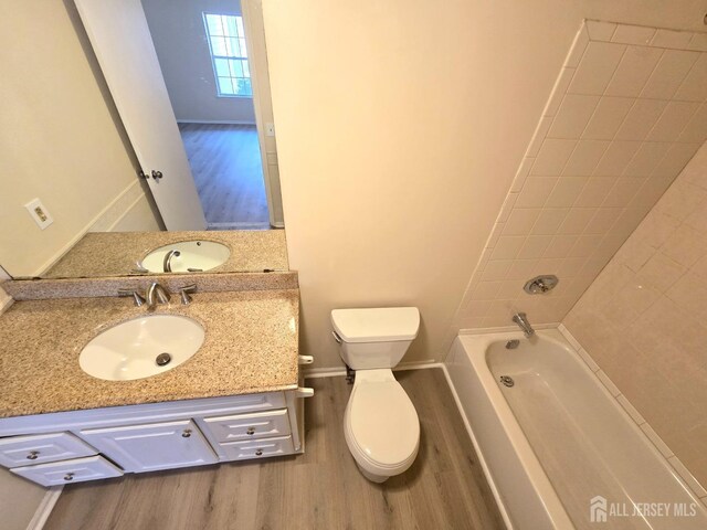 bathroom with vanity, wood-type flooring, and toilet