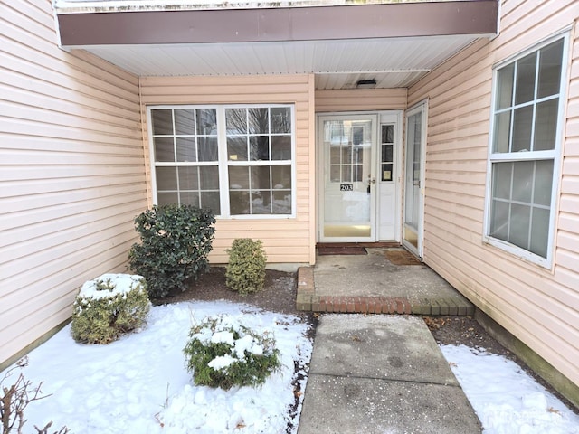 view of snow covered property entrance