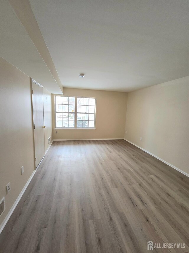 spare room with hardwood / wood-style flooring