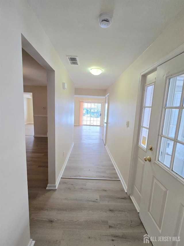 hallway with light wood-type flooring