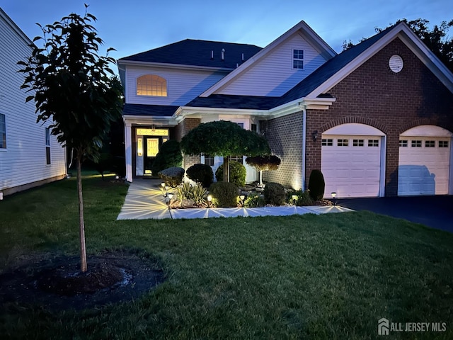 267 Tyler Ct, Monroe, NJ 08831 - traditional home with brick siding, an attached garage, a front yard, and driveway