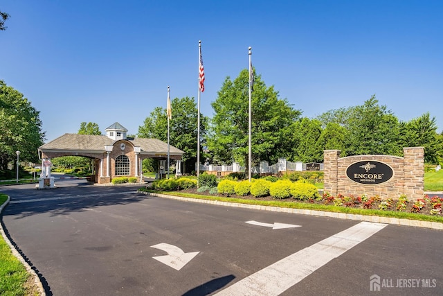 267 Tyler Ct, Monroe, NJ 08831 - view of asphalt road featuring curbs, street lights, and a gated entry