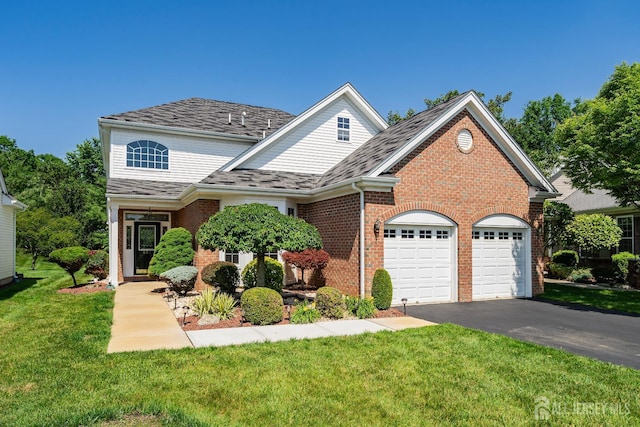 267 Tyler Ct, Monroe, NJ 08831 - traditional home with an attached garage, brick siding, asphalt driveway, and a front lawn