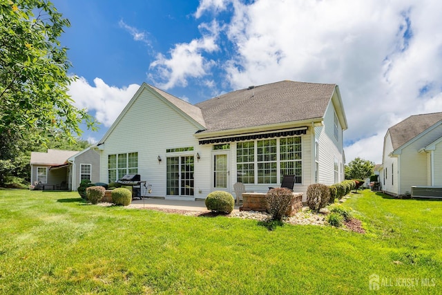 267 Tyler Ct, Monroe, NJ 08831 - rear view of house with a patio, a yard, and roof with shingles