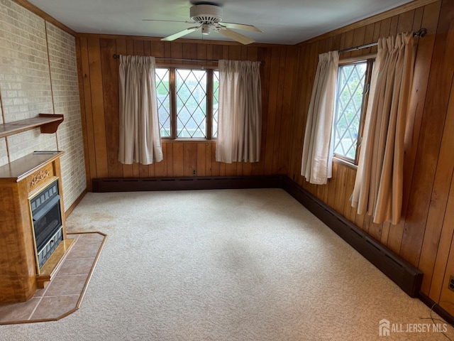 161 Manor St, South Amboy, NJ 08879 - unfurnished living room featuring plenty of natural light, wooden walls, ceiling fan, brick wall, and a fireplace