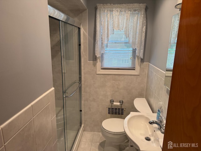 161 Manor St, South Amboy, NJ 08879 - full bath featuring tile walls, a stall shower, tile patterned floors, a wainscoted wall, and radiator