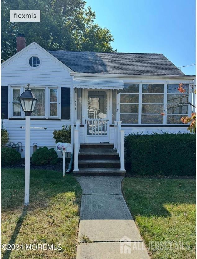 161 Manor St, South Amboy, NJ 08879 - bungalow with a front lawn, roof with shingles, and a chimney