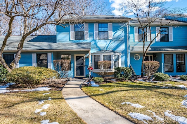 traditional-style home featuring a front yard