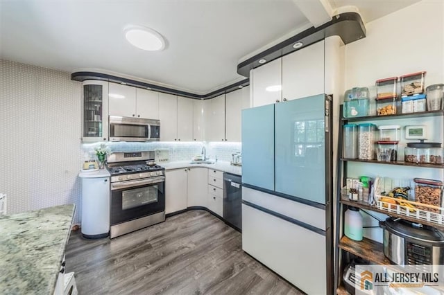 47 Pheasant Run Unit 47, Edison, NJ 08820 - kitchen with stainless steel appliances, white cabinetry, dark wood finished floors, wallpapered walls, and glass insert cabinets