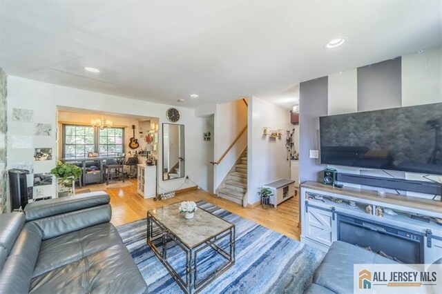 47 Pheasant Run Unit 47, Edison, NJ 08820 - living area with a chandelier, light wood-style flooring, stairs, and recessed lighting