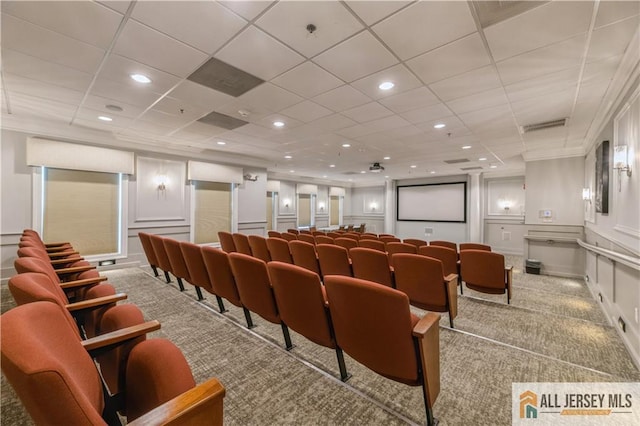 carpeted home theater room featuring recessed lighting, visible vents, and a decorative wall