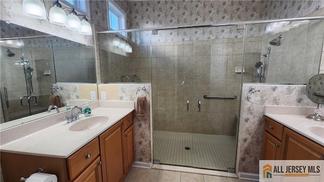 bathroom with a stall shower, tile patterned flooring, and vanity