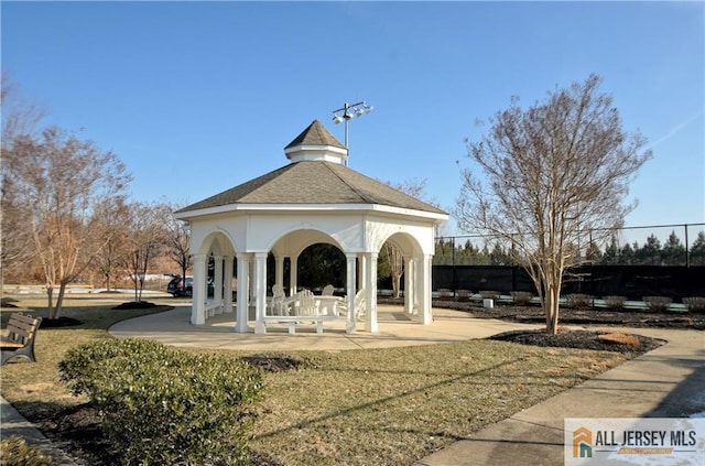 view of property's community with a gazebo and fence