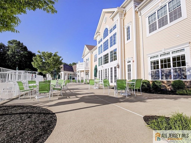 view of property's community with a patio, fence, and a residential view