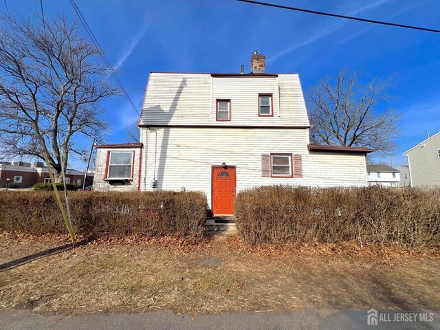 view of front of house featuring a chimney