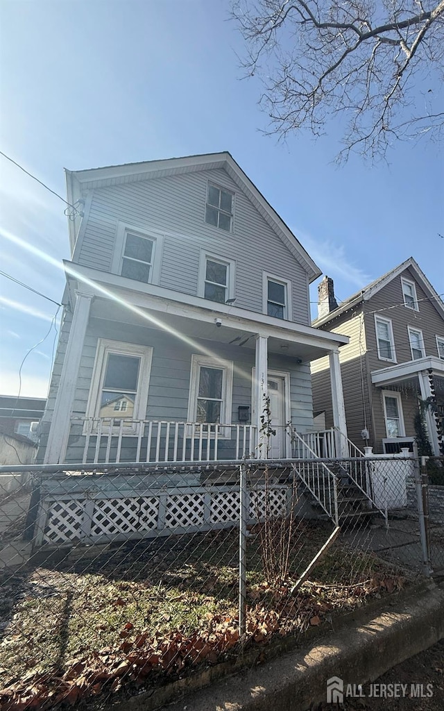 rear view of property featuring a porch