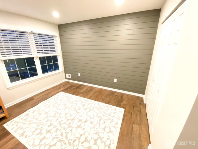 122 Arbor Way, Branchburg, NJ 08876 - empty room featuring wood finished floors, wooden walls, baseboards, and recessed lighting