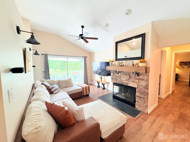 122 Arbor Way, Branchburg, NJ 08876 - living room with a ceiling fan, vaulted ceiling, a stone fireplace, light wood-style flooring, and baseboards