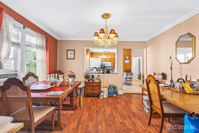 305 Penfield Pl, Dunellen, NJ 08812 - dining space with a chandelier, crown molding, and wood finished floors