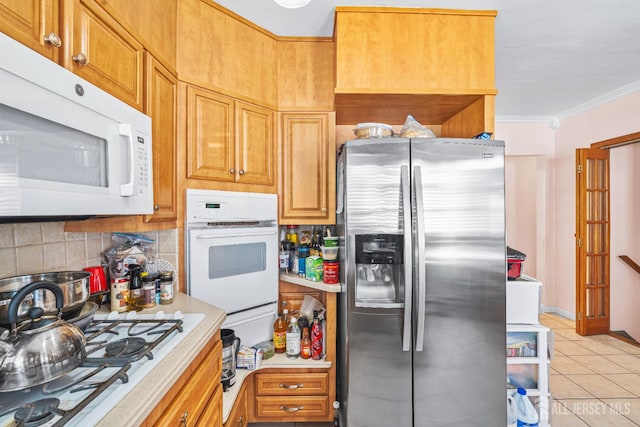 305 Penfield Pl, Dunellen, NJ 08812 - kitchen featuring white appliances, crown molding, light countertops, decorative backsplash, and light tile patterned floors
