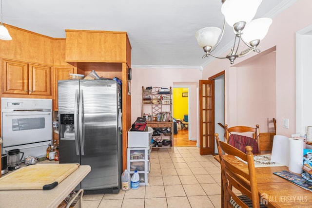305 Penfield Pl, Dunellen, NJ 08812 - kitchen featuring stainless steel fridge, oven, ornamental molding, light tile patterned floors, and french doors