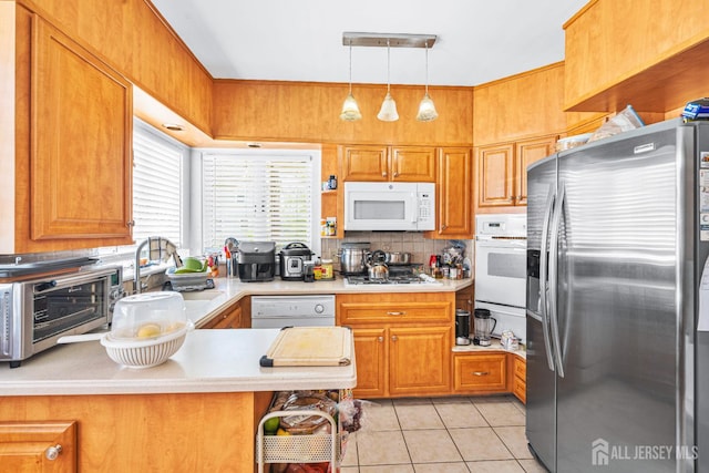 305 Penfield Pl, Dunellen, NJ 08812 - kitchen with white appliances, light countertops, light tile patterned floors, brown cabinets, and a peninsula
