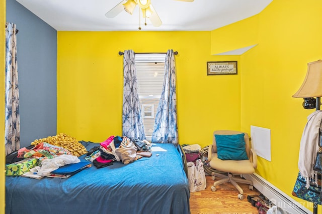 305 Penfield Pl, Dunellen, NJ 08812 - bedroom with wood finished floors, ceiling fan, and baseboard heating