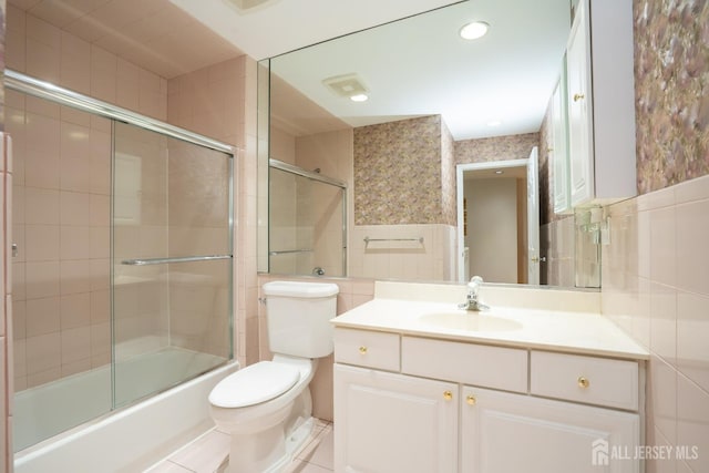 5 Fairmount Ct, Monroe, NJ 08831 - bathroom featuring tile walls, vanity, shower / bath combination with glass door, a wainscoted wall, and tile patterned floors