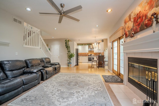 5 Fairmount Ct, Monroe, NJ 08831 - living area featuring ceiling fan, recessed lighting, a tiled fireplace, a chandelier, and stairs