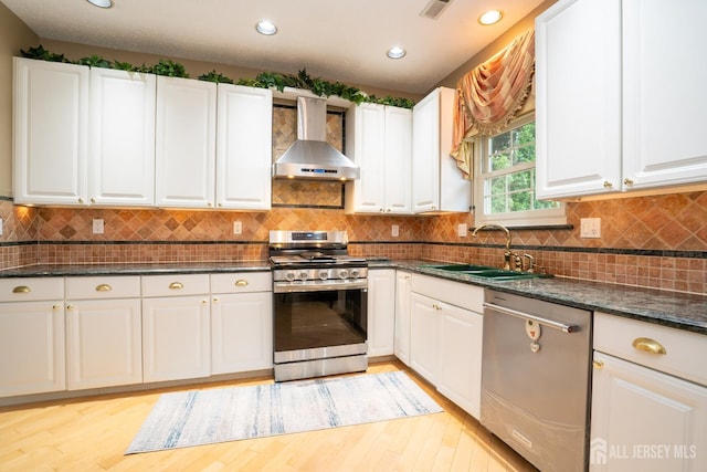 5 Fairmount Ct, Monroe, NJ 08831 - kitchen featuring wall chimney exhaust hood, appliances with stainless steel finishes, white cabinets, light wood finished floors, and recessed lighting