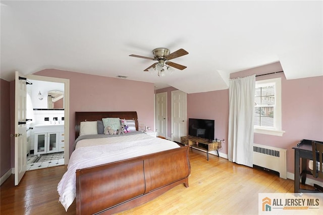 241 E Chestnut Ave, Metuchen, NJ 08840 - bedroom with radiator heating unit, wood finished floors, lofted ceiling, baseboards, and a ceiling fan