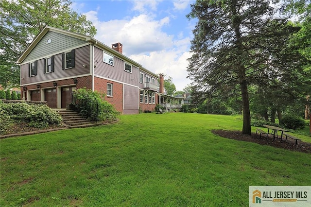 241 E Chestnut Ave, Metuchen, NJ 08840 - view of grassy yard featuring an attached garage